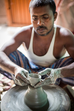 Man making a chai cup on pottery wheel